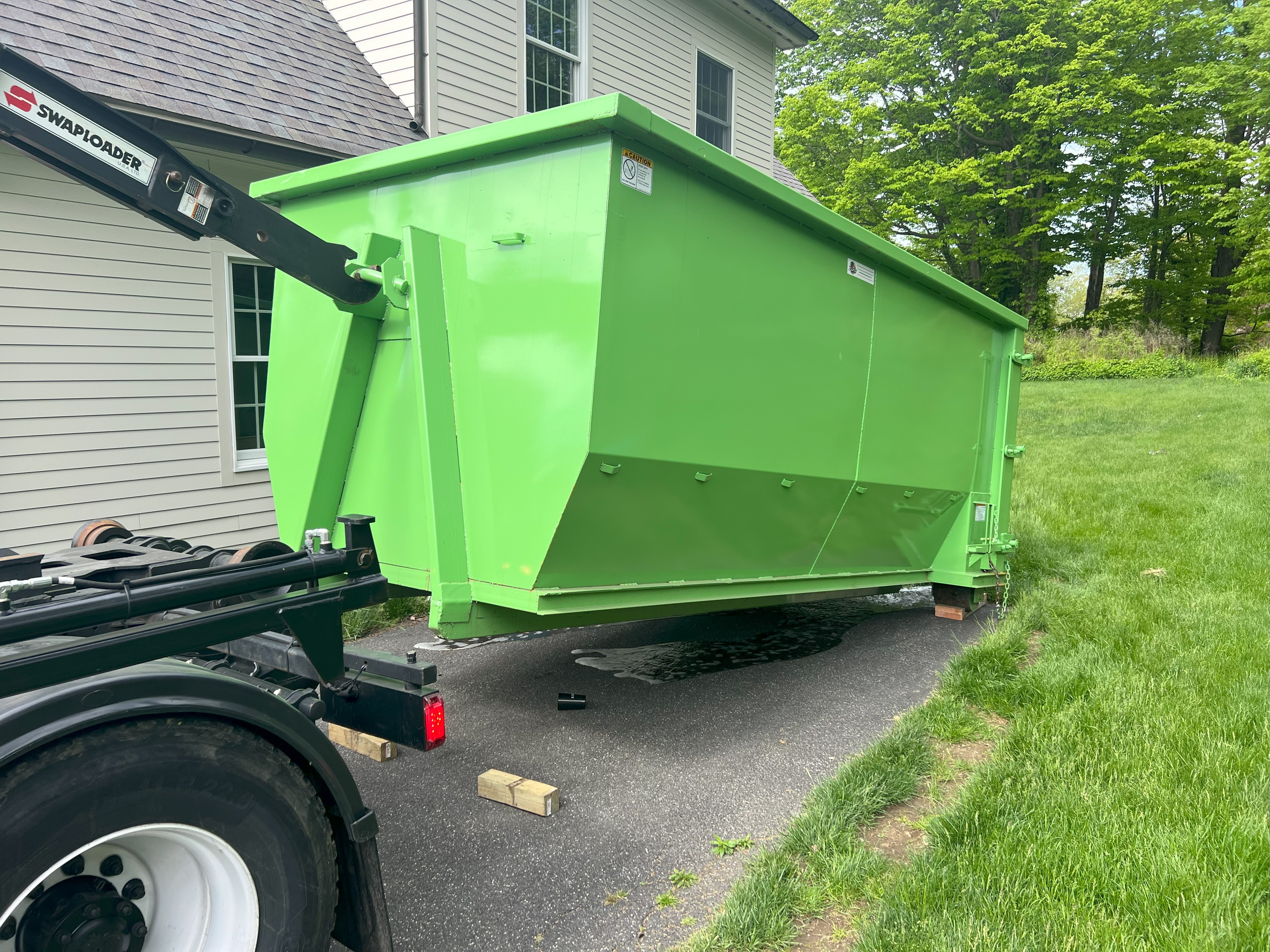 Dumpster being delivered to residential home