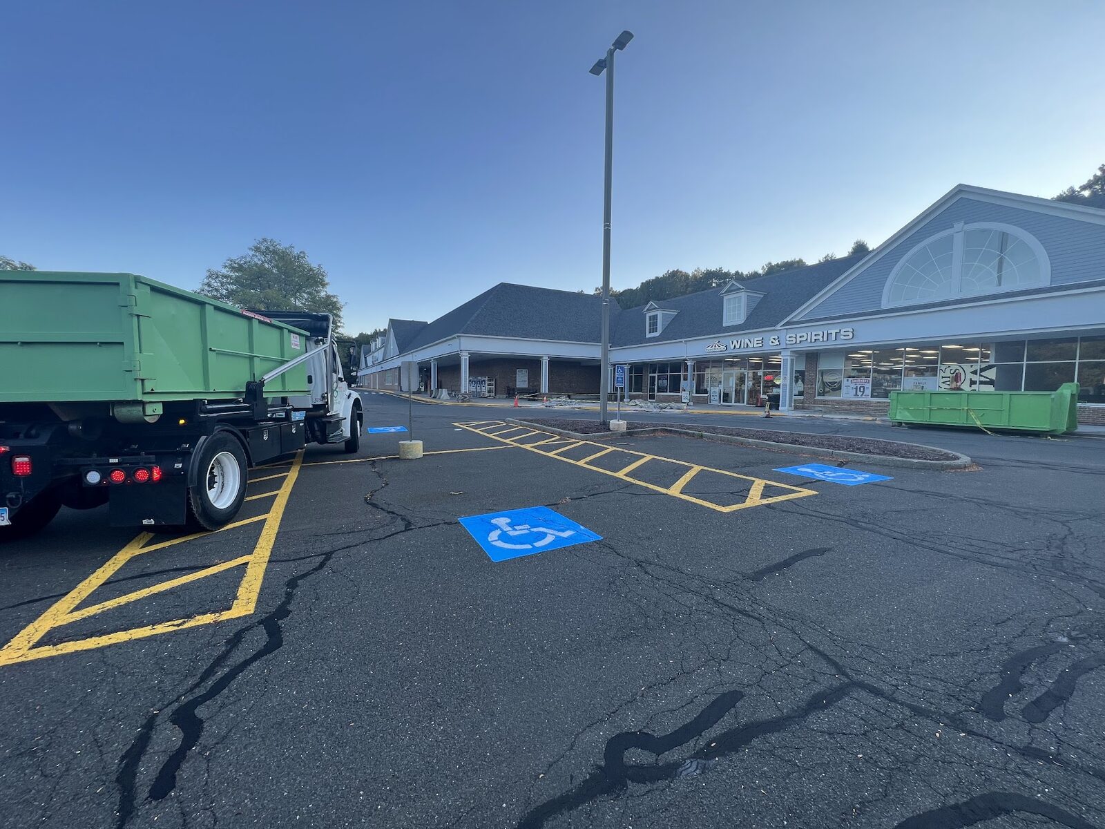 Commercial dumpster delivery at retail plaza