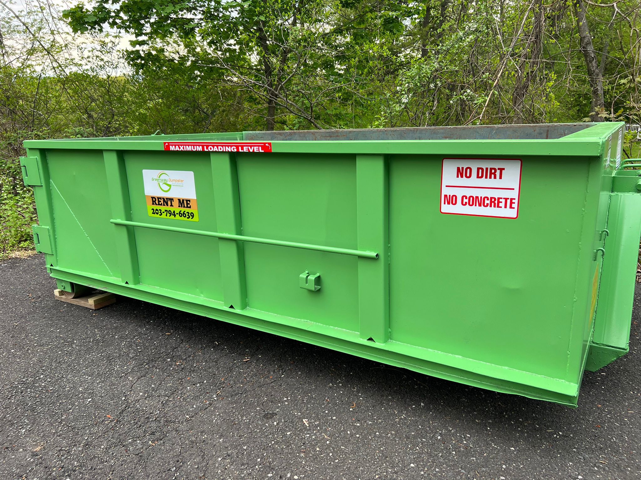 Green dumpster in winter setting